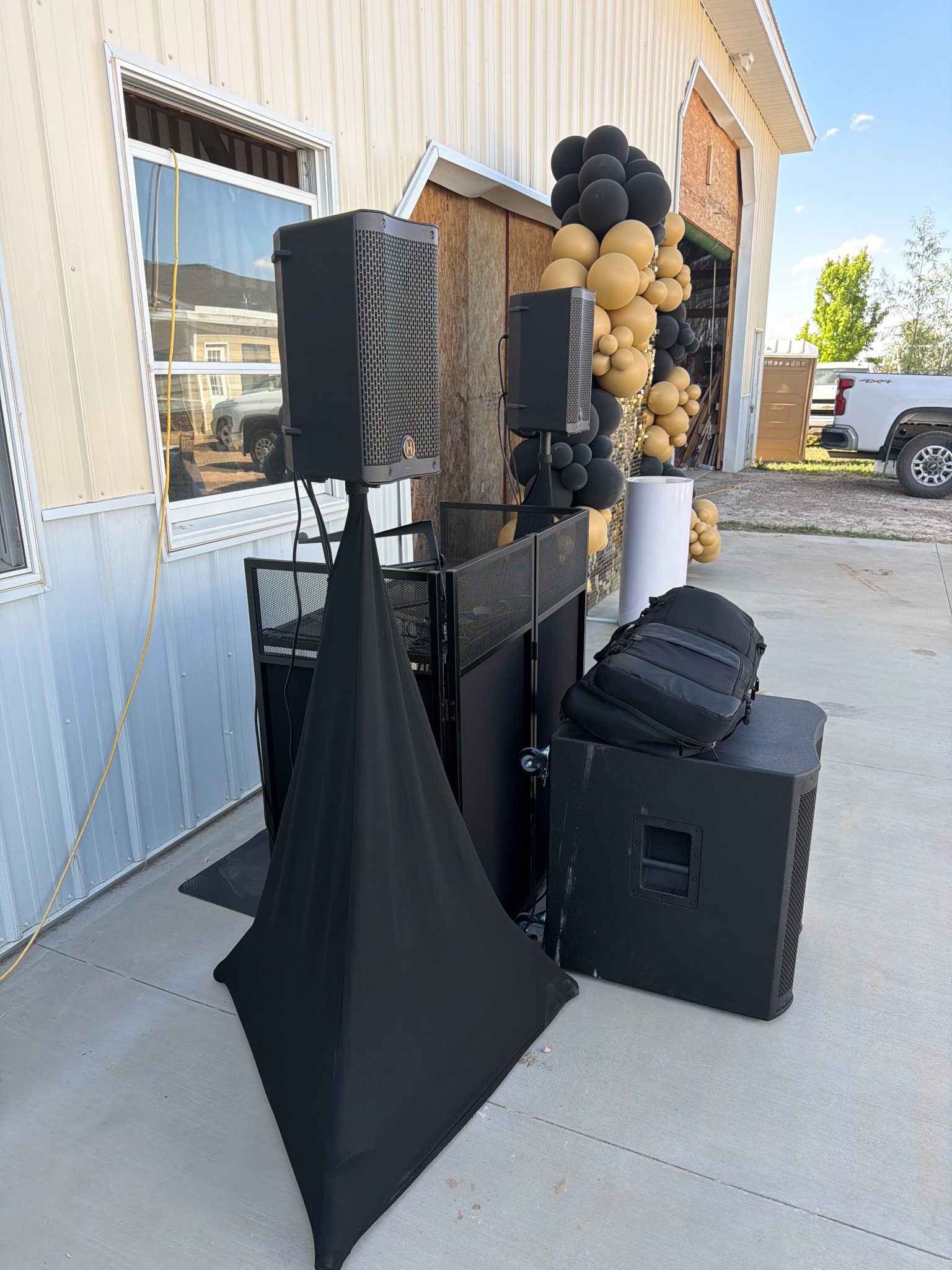 Outdoor DJ booth with speakers and a subwoofer